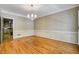 Hardwood floors and chair rail in a formal dining room with elegant chandelier at 2935 Abbottswell Dr, Alpharetta, GA 30022