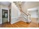 Classic foyer showcasing hardwood floors, staircase, and doorway to other rooms at 2935 Abbottswell Dr, Alpharetta, GA 30022