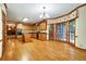 Eat-in kitchen with wood cabinets, hardwood floors, and a bright bay window area at 2935 Abbottswell Dr, Alpharetta, GA 30022