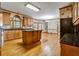 Eat in Kitchen with wooden cabinetry, a center island, and hardwood floors at 2935 Abbottswell Dr, Alpharetta, GA 30022