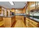 Traditional kitchen with wood cabinets, granite countertops, and an island, offering ample space and classic style at 2935 Abbottswell Dr, Alpharetta, GA 30022
