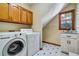 Bright laundry room featuring a washer, dryer, and countertop sink at 2935 Abbottswell Dr, Alpharetta, GA 30022