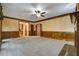 Large living room featuring wood trim, ceiling fan, and a brick fireplace hearth at 2935 Abbottswell Dr, Alpharetta, GA 30022