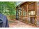 Inviting screened-in porch with wood flooring and railing, providing a tranquil outdoor living space at 2935 Abbottswell Dr, Alpharetta, GA 30022