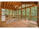 Relaxing sunroom with wood ceiling, fan, and views of the surrounding trees, perfect for enjoying nature indoors at 2935 Abbottswell Dr, Alpharetta, GA 30022