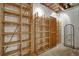 Spacious wine cellar with wooden racks and shelving for wine bottles at 2935 Abbottswell Dr, Alpharetta, GA 30022