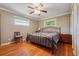 Bedroom with hardwood floors, windows, and bed at 3212 Georgian Woods Cir, Decatur, GA 30034