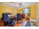 Bright bedroom with yellow walls, ceiling fan, and hardwood floors at 3212 Georgian Woods Cir, Decatur, GA 30034