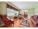 Cozy living room with hardwood floors, large window, crown molding, and comfortable seating at 3212 Georgian Woods Cir, Decatur, GA 30034