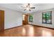 Well-lit bedroom with two windows, ceiling fan, wood-style laminate flooring, and ensuite bathroom access at 3442 Winter Wood Trl, Marietta, GA 30062