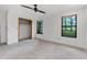 Bedroom with neutral carpet, ceiling fan, and two windows with a view at 3442 Winter Wood Trl, Marietta, GA 30062