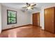 Bedroom with hardwood floors, window view, ceiling fan, and closet at 3442 Winter Wood Trl, Marietta, GA 30062