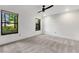 Bright bedroom with neutral carpet, ceiling fan, and ample natural light from two windows at 3442 Winter Wood Trl, Marietta, GA 30062
