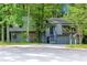 Two story home nestled amongst beautiful trees with a two-car garage and gray exterior at 3442 Winter Wood Trl, Marietta, GA 30062
