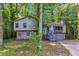 Two story gray home nestled in a wooded area features a two-car garage at 3442 Winter Wood Trl, Marietta, GA 30062