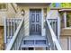 Stylish front door with a gray wood-slatted exterior and wooden staircase at 3442 Winter Wood Trl, Marietta, GA 30062