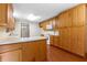 Bright kitchen with light countertops, natural wood cabinetry, and stainless steel appliances at 3442 Winter Wood Trl, Marietta, GA 30062
