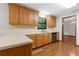 Functional kitchen featuring laminate countertops, stainless steel sink, and wood-style laminate flooring at 3442 Winter Wood Trl, Marietta, GA 30062
