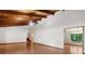 Spacious living room with beamed ceiling and hardwood floors offers access to upper level and dining room at 3442 Winter Wood Trl, Marietta, GA 30062