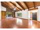 Spacious living room with wood floors, beamed ceiling, stone fireplace with built-ins, and large window for natural light at 3442 Winter Wood Trl, Marietta, GA 30062