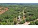 Wide aerial view of home and wooded lot in a secluded community with map pin on the roof at 411 Johnson Rd, Locust Grove, GA 30248