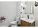 Bathroom featuring a wood vanity, modern fixtures, decorative mirror and a single bowl sink at 411 Johnson Rd, Locust Grove, GA 30248