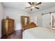 Bedroom with wooden floors, a wooden bed frame, and a sliding barn door at 411 Johnson Rd, Locust Grove, GA 30248