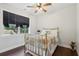 Bedroom with a metal-framed bed, wood floors, and natural light at 411 Johnson Rd, Locust Grove, GA 30248