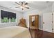 Bedroom featuring wood floors, a wooden bed frame, and natural light at 411 Johnson Rd, Locust Grove, GA 30248