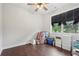 Bright bedroom with dark wood floors and large window at 411 Johnson Rd, Locust Grove, GA 30248