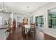 Bright dining room features a chandelier, a table for six, and sliding glass doors to the outside patio at 411 Johnson Rd, Locust Grove, GA 30248