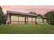 Back exterior of the home showing a wall of windows bringing the outside in and lots of natural light at 411 Johnson Rd, Locust Grove, GA 30248
