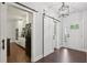 Inviting foyer with hardwood floors, barn door, and view into the bright kitchen at 411 Johnson Rd, Locust Grove, GA 30248