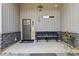 Charming covered front porch with a bench, decorative plants, stone accents and gray siding at 411 Johnson Rd, Locust Grove, GA 30248