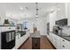 Bright, open kitchen featuring granite counters, white cabinets, stainless appliances and a central prep island at 411 Johnson Rd, Locust Grove, GA 30248