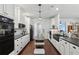 Stylish kitchen with white cabinetry, granite countertops, stainless appliances, and a central island at 411 Johnson Rd, Locust Grove, GA 30248