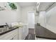 Well-equipped laundry room featuring a sink, counter space, and modern washer and dryer units at 411 Johnson Rd, Locust Grove, GA 30248