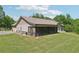View of back of house featuring enclosed patio, and a lush green lawn at 411 Johnson Rd, Locust Grove, GA 30248