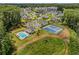 Overhead view of community featuring a pool, tennis court, parking, and beautiful landscaping at 6080 Simone St, Acworth, GA 30101