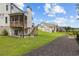 Home's manicured lawn leads to a screened in porch, with ample space for enjoyment at 6080 Simone St, Acworth, GA 30101