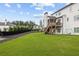 Manicured backyard featuring a screened-in porch, large lawn, and tasteful landscaping at 6080 Simone St, Acworth, GA 30101