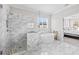 This bathroom showcases a marble walk-in shower, and a luxurious soaking tub with natural light at 6080 Simone St, Acworth, GA 30101