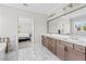An expansive bathroom with marble flooring, dual vanity, and view to bedroom at 6080 Simone St, Acworth, GA 30101
