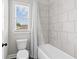 This bathroom features a bathtub with shower and a white toilet at 6080 Simone St, Acworth, GA 30101
