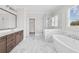 A luxurious bathroom with a freestanding tub, marble surround shower, and dual vanity at 6080 Simone St, Acworth, GA 30101