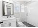 Modern bathroom with white subway tile, glass enclosed shower, dark shower floor, and vanity with black hardware at 6080 Simone St, Acworth, GA 30101
