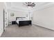 Spacious bedroom with tray ceiling, plush carpet, and windows bringing in natural light at 6080 Simone St, Acworth, GA 30101