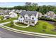 Aerial view of a two-story white home with a landscaped yard nestled in a serene, wooded neighborhood at 6080 Simone St, Acworth, GA 30101