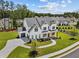 Aerial view of a two-story white home with a driveway and landscaped front yard in a wooded neighborhood at 6080 Simone St, Acworth, GA 30101