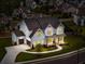 Twilight aerial view of a two-story white home, showcasing a beautiful driveway and landscaped front yard at 6080 Simone St, Acworth, GA 30101